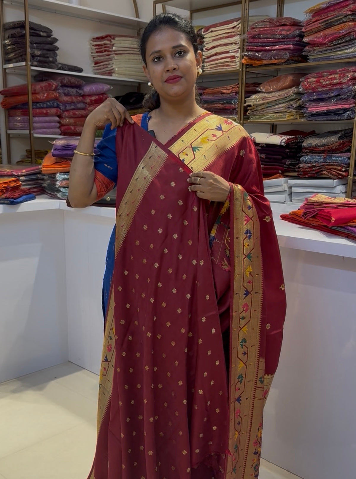 Maroon dola silk saree with paithani border.