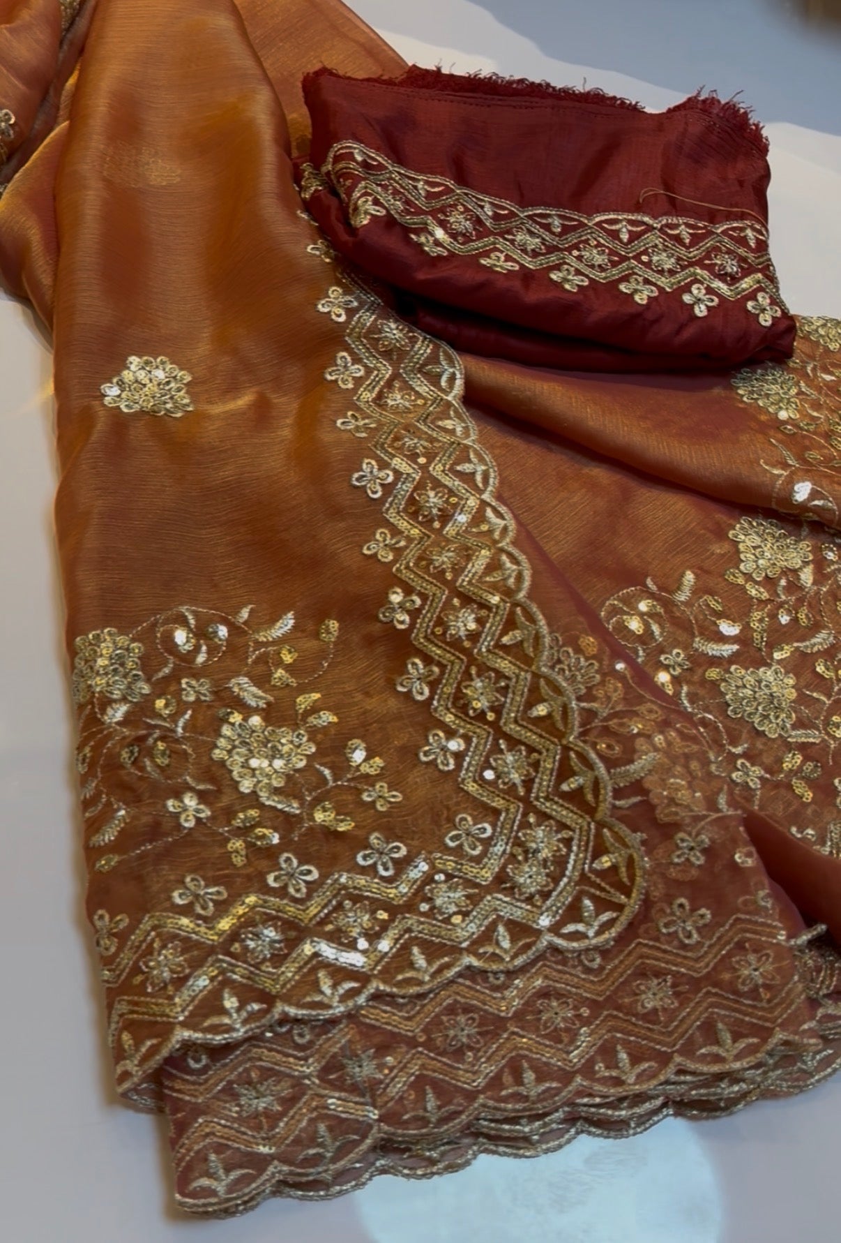 Rust orange fluid organza saree